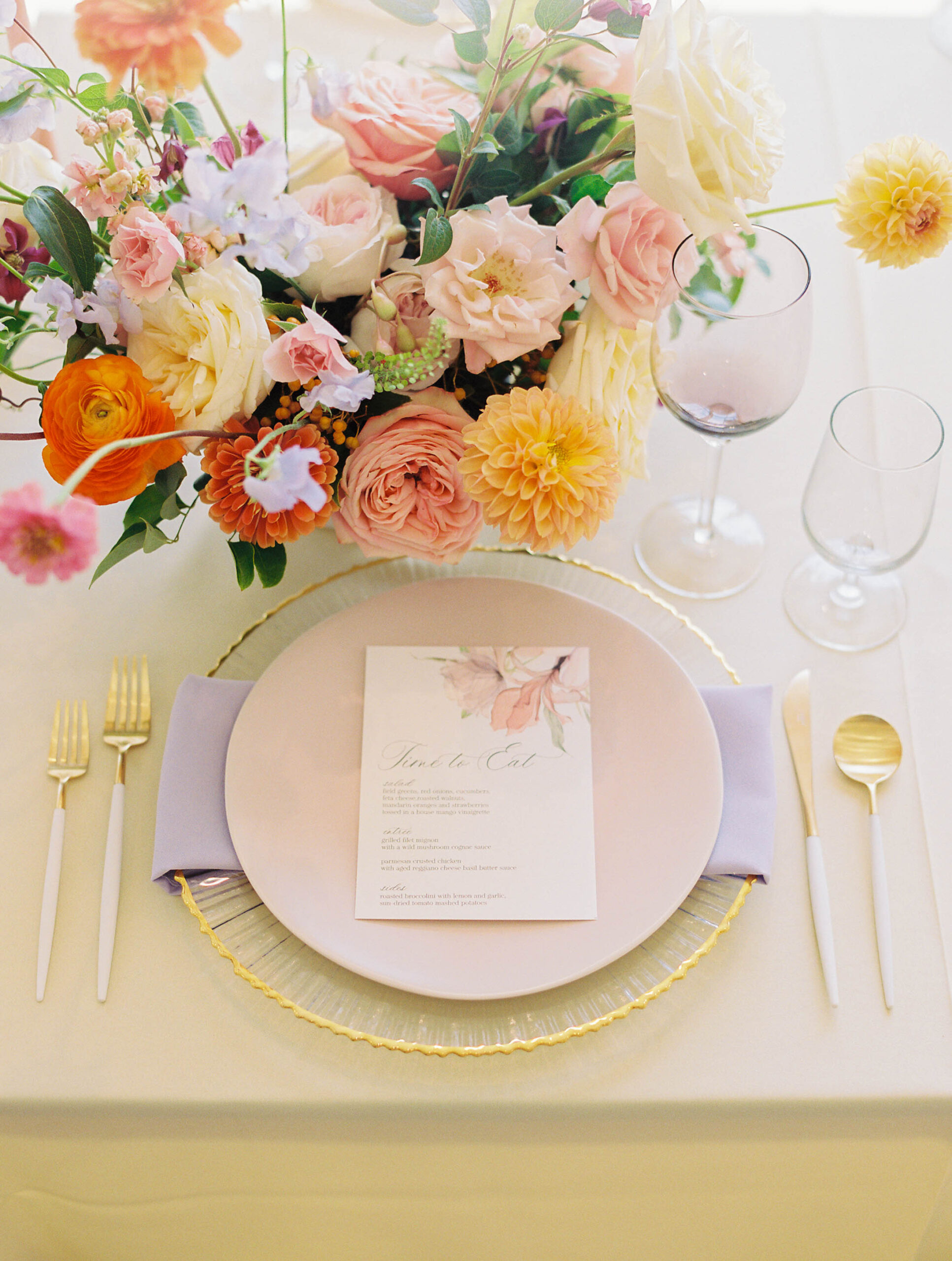 wedding reception table place setting with colorful floral arrangement wedding reception table place setting with colorful floral arrangement